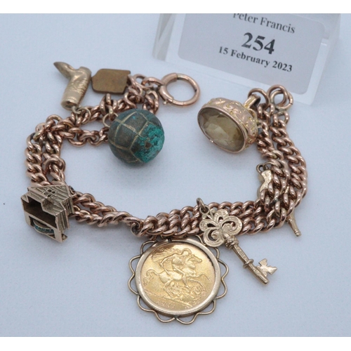 254 - 9ct gold charm bracelet with various gold and other metal charms, including; George V half sovereign... 