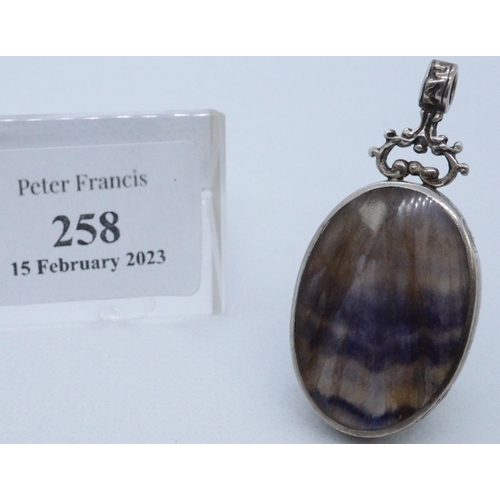 258 - Silver framed oval Blue John stone pendant with rococo suspension loop.
(B.P. 21% + VAT)