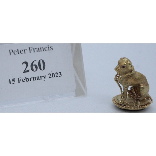 260 - Yellow metal hound or dog shaped charm with semi-precious stone set into base. 
(B.P. 21% + VAT)