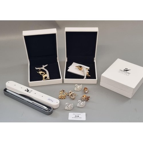 210 - Collection of Swarovski crystal items, to include: pen in original box, animal and other brooches in... 