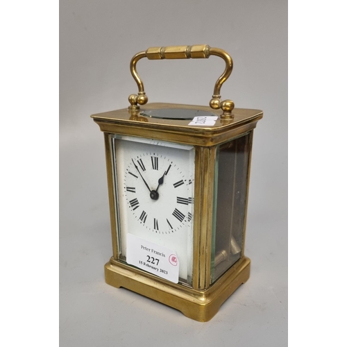 227 - Early 20th century brass carriage clock with enamel face and Roman numerals, with key.  (B.P. 21% + ... 