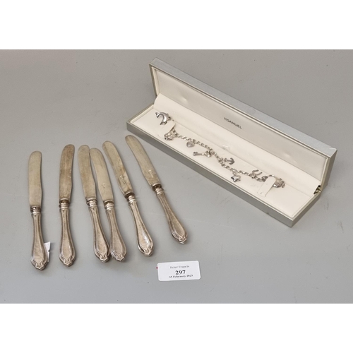 297 - Set of six silver handled dessert knives with steel blades, together with a silver charm bracelet, c... 