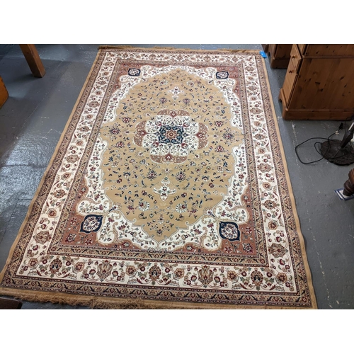 632 - Modern Persian design floral and foliate rug on a beige ground with central flowerhead medallion.  3... 