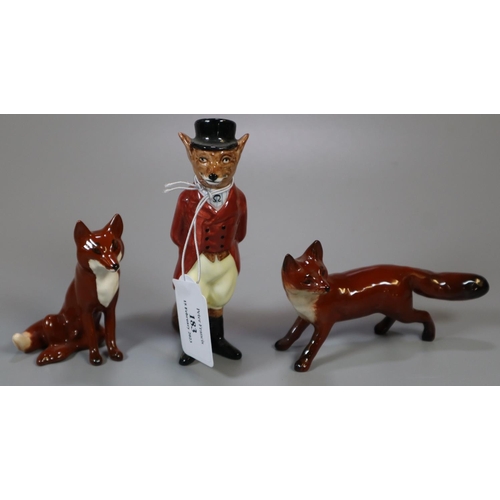 183 - Two Beswick foxes together with a Royal Doulton satirical fox dressed in hunting cloths.  (3)  (B.P.... 