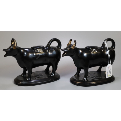 161 - Two black glazed cow creamers with gilt detailing. (2)
(B.P. 21% + VAT)