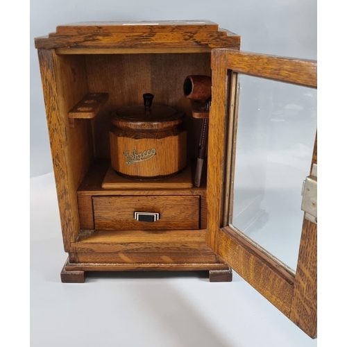 71 - Early 20th century oak smoker's cabinet with fitted interior, wooden tobacco jar and glazed door.  3... 