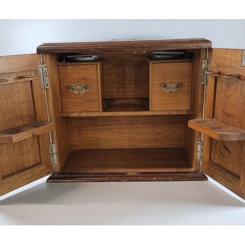 72 - Early 20th century oak two door smoker's cabinet with fitted interior.  36cm wide approx.  (B.P. 21%... 