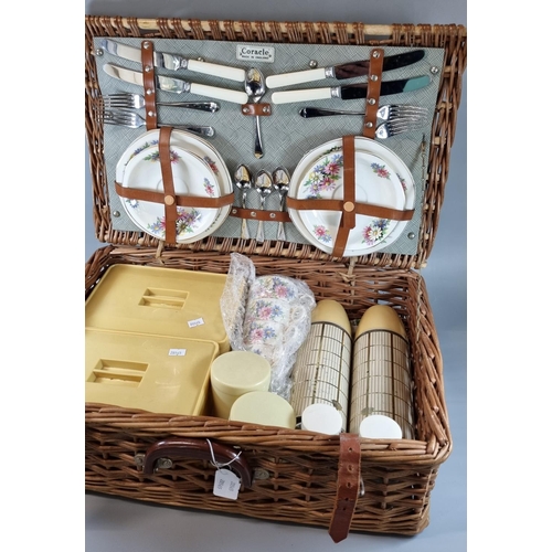 83 - Fully fitted cane/wicker picnic hamper.  Together with a Japanese parasol.  (2)  (B.P. 21% + VAT)