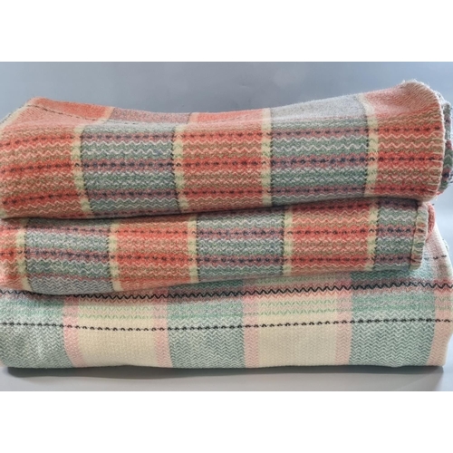 93 - Three vintage woollen check blankets or carthen with fringed edges, two in the same colours and one ... 