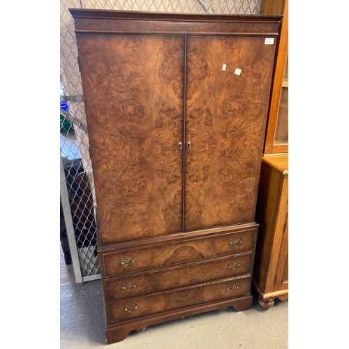 444 - Reproduction walnut two door blind panelled cabinet above three long drawers on bracket feet.  (B.P.... 