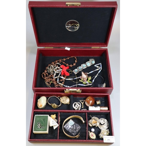 284 - Red jewellery case containing assorted costume jewellery: pendants, bangles, brooches, hardstone etc... 