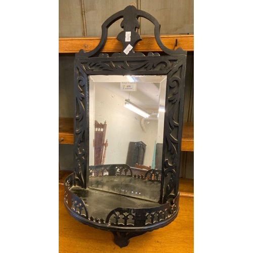 450 - Edwardian ebonised fret cut beveled hanging wall mirror with under shelf.  (B.P. 21% + VAT)