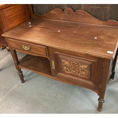 459 - Edwardian mahogany side table, having gallery top above ornately carved door on turned supports.  (B... 