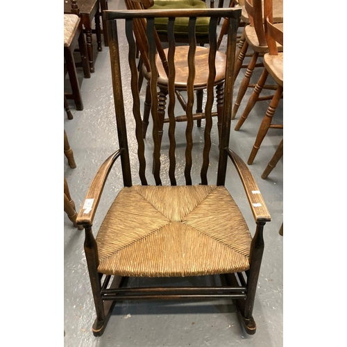 484 - 1930s stained slat backed rocking low nursing chair with seagrass seat.  (B.P. 21% + VAT)