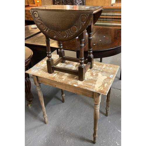 493 - 17th century style carved oak drop leaf table (20th century), together with a rustic pine side table... 