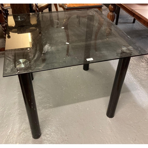 500 - Modern smokey glass topped table of square form standing on tubular legs.  (B.P. 21% + VAT)