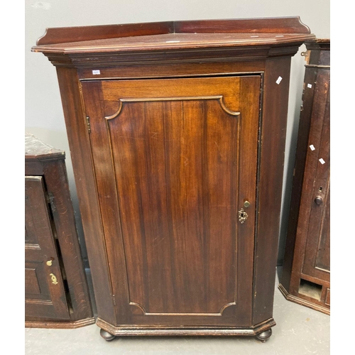 537 - 19th century mahogany blind panelled corner cupboard, now on bun feet with low gallery back, shaped ... 