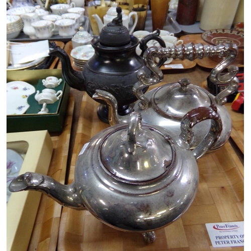 369 - Three teapots: one black basalt teapot with girl knop and pedestal base and two silvered ceramic tea... 