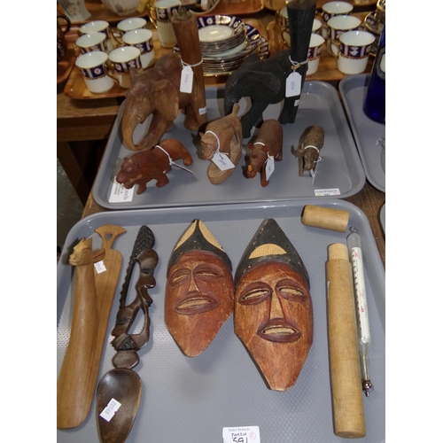 391 - Two trays of carved tribal items: two elephant lamp stands, rhinoceros, lion, face masks etc. and a ... 