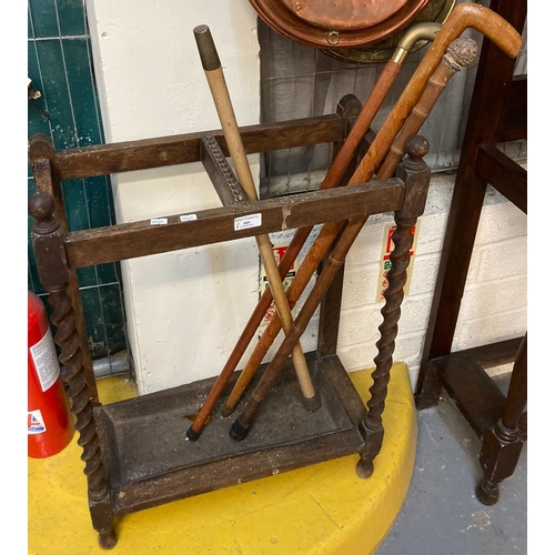 589 - Oak barley twist umbrella stand together with four walking sticks.  (B.P. 21% + VAT)