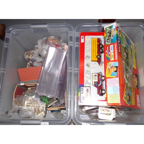 404 - Two plastic boxes of Britains boxed models, various, to include: livestock building, New Holland bal... 