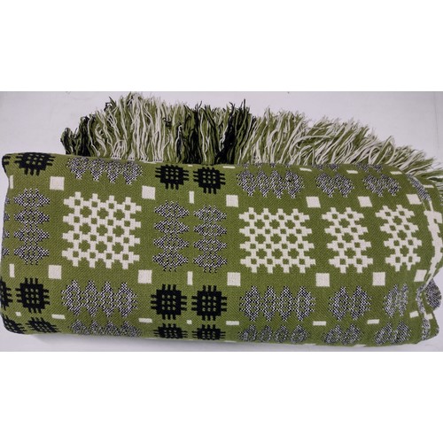 93A - Vintage woollen Welsh tapestry green ground blankets; one olive green with fringed edges in traditio... 