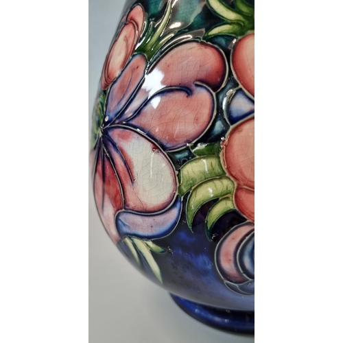 148 - Moorcroft Art Pottery tube lined 'Anemone' pattern vase, of baluster tapering form.  25cm high appro... 