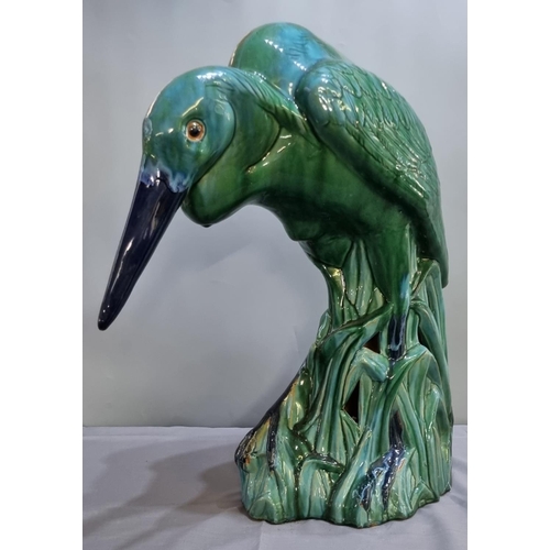 156 - Unusual Majolica pottery study of a Heron in a natural setting of reeds, in stooped pose.  67cm high... 