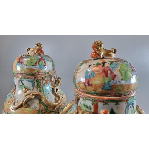 163 - Pair of Canton famille rose baluster vases and covers, decorated all over with panels of figures in ... 