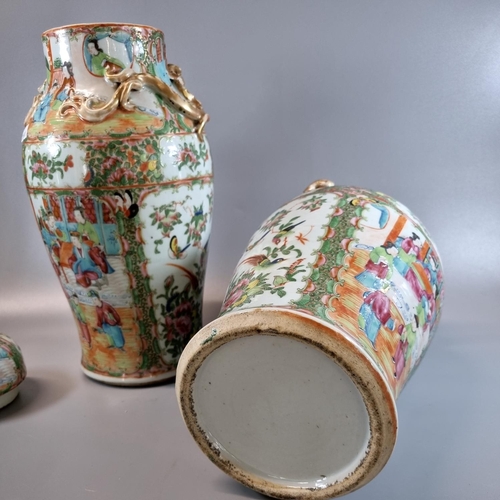 163 - Pair of Canton famille rose baluster vases and covers, decorated all over with panels of figures in ... 