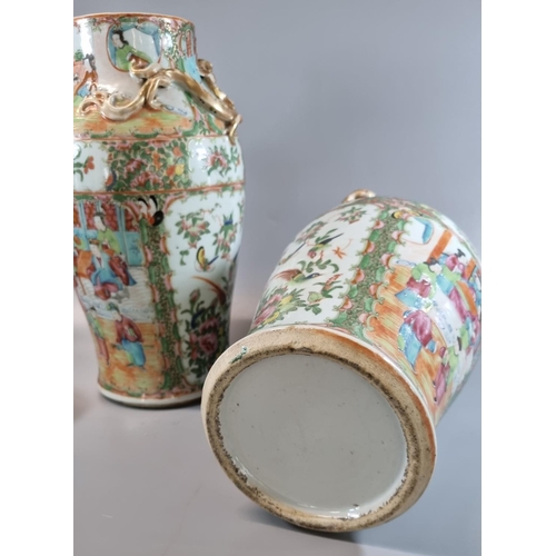 163 - Pair of Canton famille rose baluster vases and covers, decorated all over with panels of figures in ... 