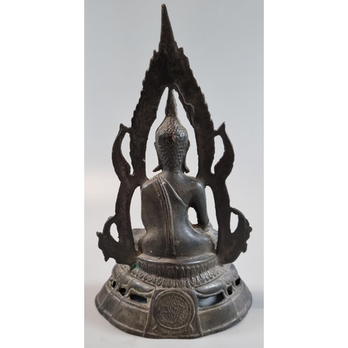 173 - Thai cast yellow metal patinated figure of a seated Shakyamuni Buddha, framed in flaming mandala.  2... 