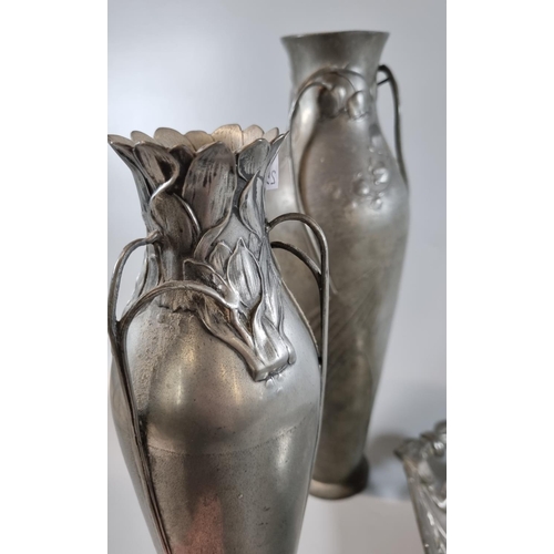 182 - Two similar Kayserzinn Art Nouveau pewter vases with floral swing handles and raised organic decorat... 