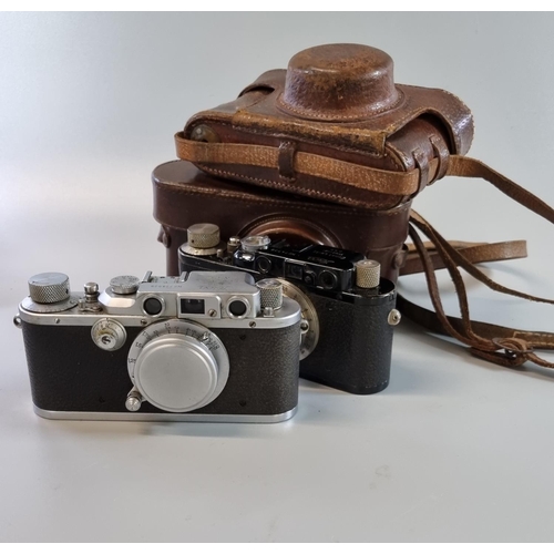 186 - Two Leica viewfinder roll film cameras, both with F50mm Leitz Elmar standard lenses, one having blac... 