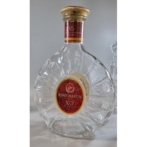 197 - Five similar Remy Martin Baccarat glass cognac decanters and stoppers, together with a larger fine c... 