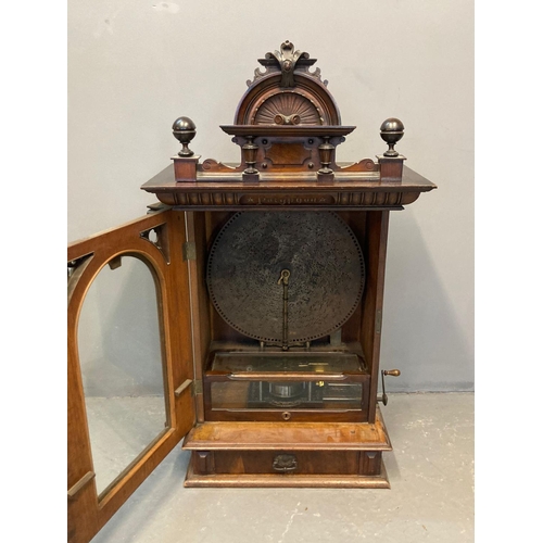 21 - Late Victorian walnut 'penny-in-the-slot' Polyphon, the architectural pediment with turned finials a... 