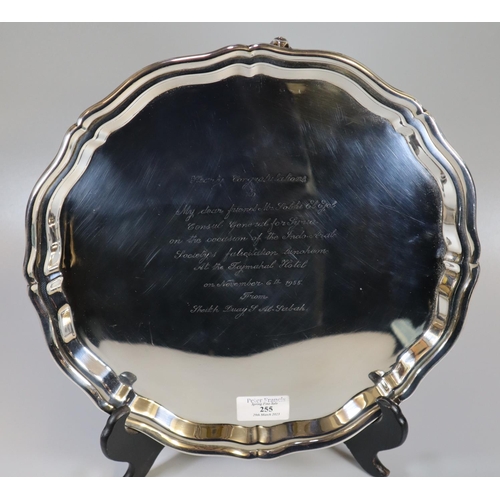 255 - Indian white metal presentation pie crust salver raised on three scroll feet, 'Hearty congratulation... 