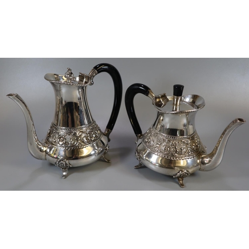 257 - Indian white metal four piece tea service comprising teapot and water jug with ebonised handles, cre... 