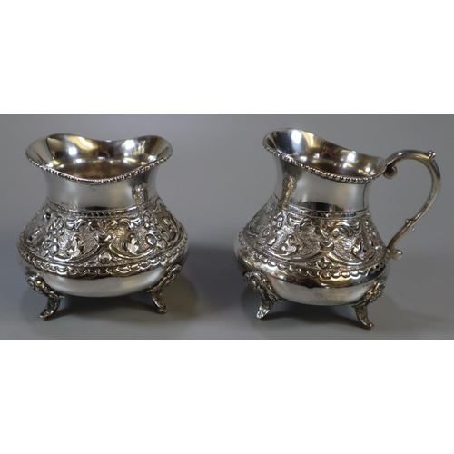 257 - Indian white metal four piece tea service comprising teapot and water jug with ebonised handles, cre... 