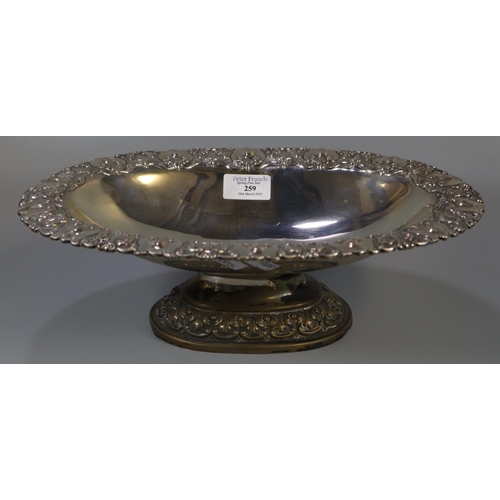 259 - Indian white metal pedestal bowl of oval form ornately embossed with swags and foliage.  33x22x10cm ... 