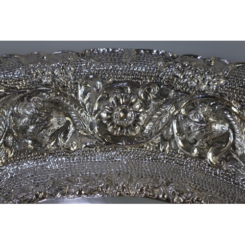 261 - Impressive Indian silver bowl, of oval form ornately embossed and decorated with flowerheads, scroll... 