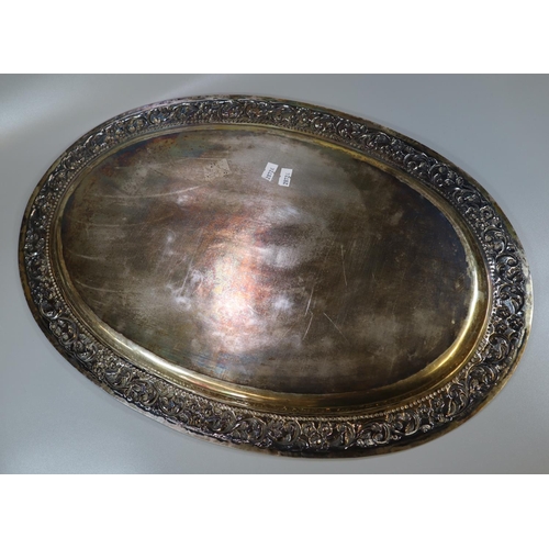 262 - Silver Indian shallow tray of oval form, overall decorated with flowerheads, scroll work and foliage... 