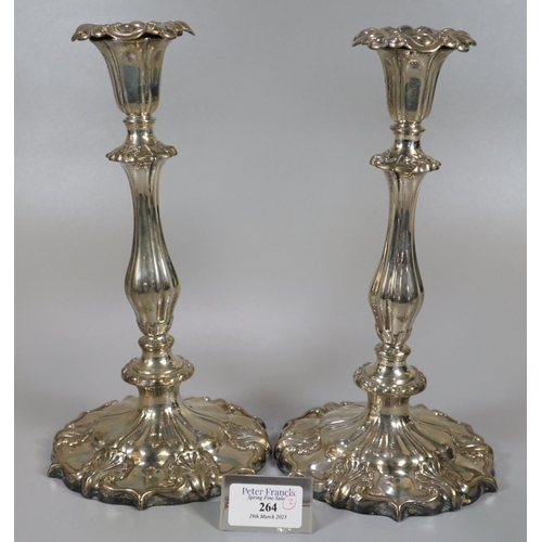 264 - Pair of mid Victorian silver candlesticks, having shaped circular loaded bases with shell decoration... 