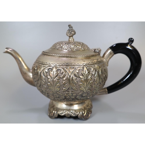 267 - Three piece Indian Silver tea service comprising: bullet shaped teapot with ebonised turned handle, ... 