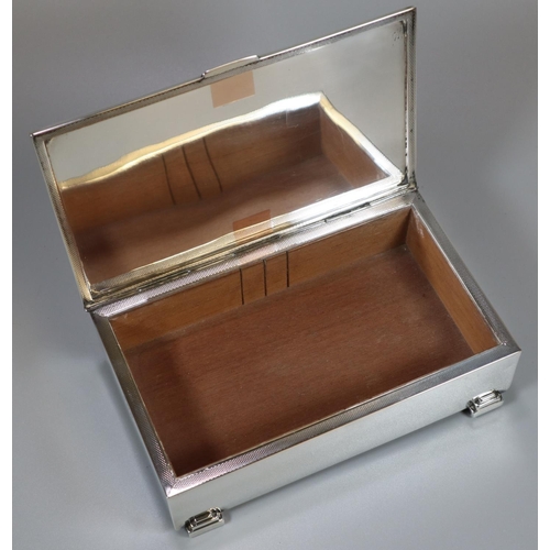 272 - Silver Art Deco cigar box, the hinged and engine turned top above four geometric stepped feet, Birmi... 