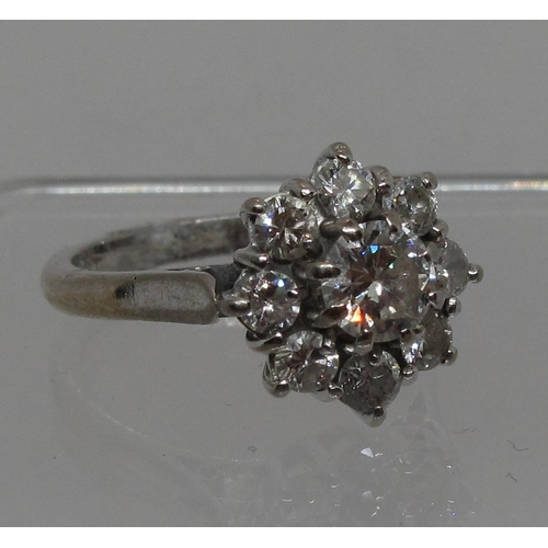 294 - Diamond cluster ring set in 18ct white gold.  The central brilliant cut diamond an estimated 0.52cts... 