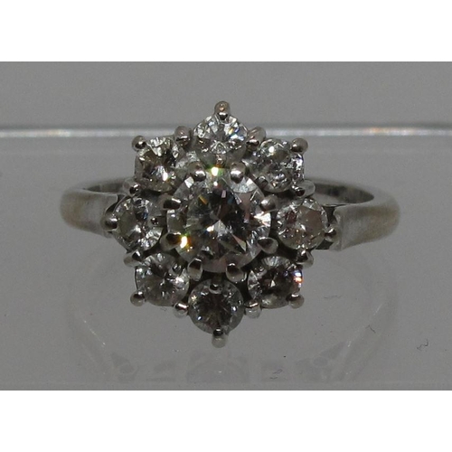 294 - Diamond cluster ring set in 18ct white gold.  The central brilliant cut diamond an estimated 0.52cts... 