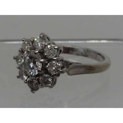 294 - Diamond cluster ring set in 18ct white gold.  The central brilliant cut diamond an estimated 0.52cts... 