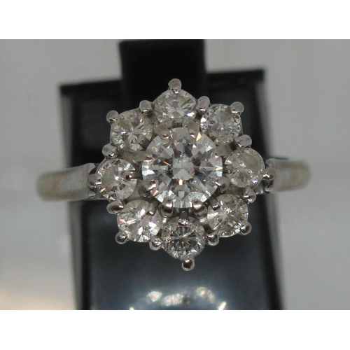 294 - Diamond cluster ring set in 18ct white gold.  The central brilliant cut diamond an estimated 0.52cts... 