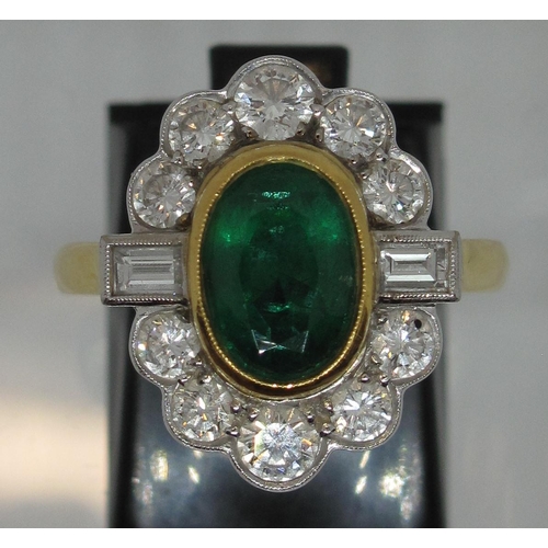 296 - A large emerald and diamond cluster ring.  The oval emerald approx 9x6mm surrounded by ten brilliant... 